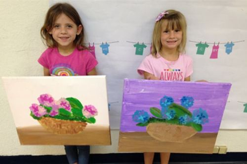 Students sharing colorful visual art projects